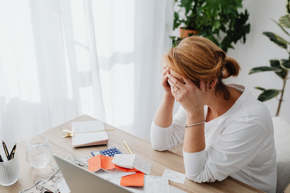 A stressed homeowner during tax season, visibly distressed, searching through mortgage records.